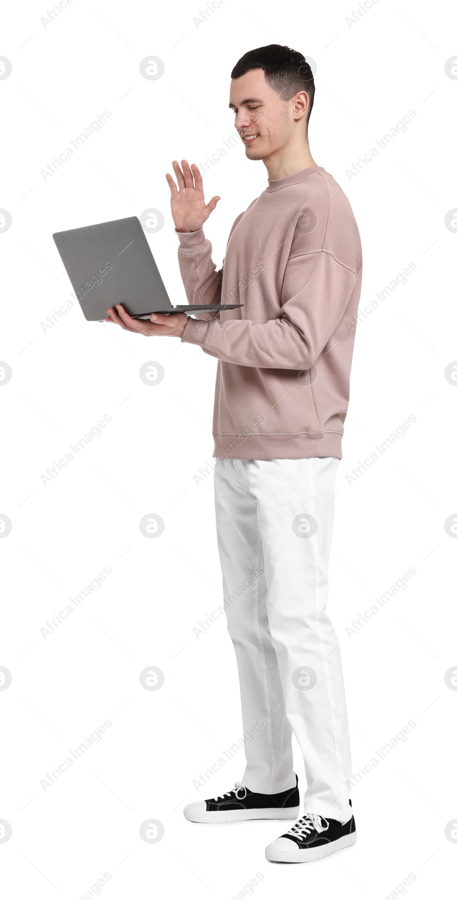 Photo of Handsome young man with laptop on white background