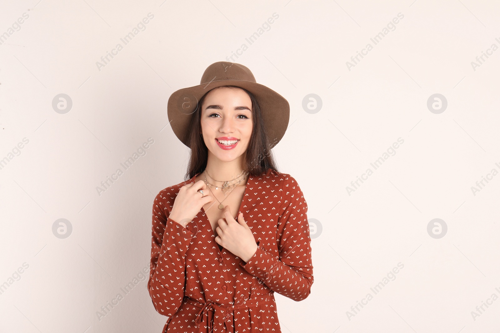 Photo of Portrait of beautiful young woman in stylish dress on white background