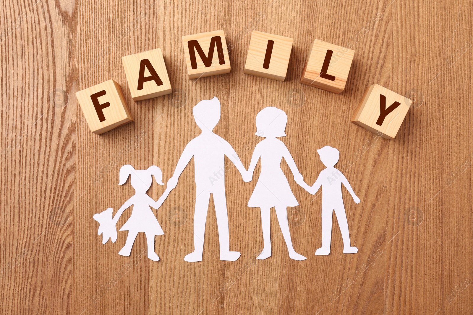 Photo of Paper cutout and word Family made of wooden cubes with letters on table, flat lay