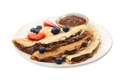 Photo of Tasty crepes with chocolate paste and berries isolated on white