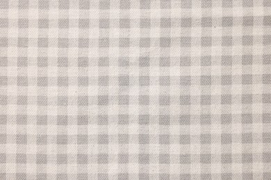 Beige checkered tablecloth as background, top view