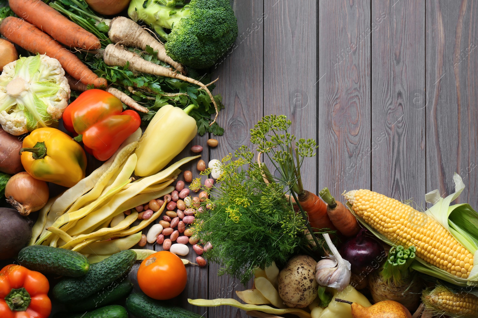 Photo of Different fresh vegetables on wooden table, flat lay. Farmer harvesting