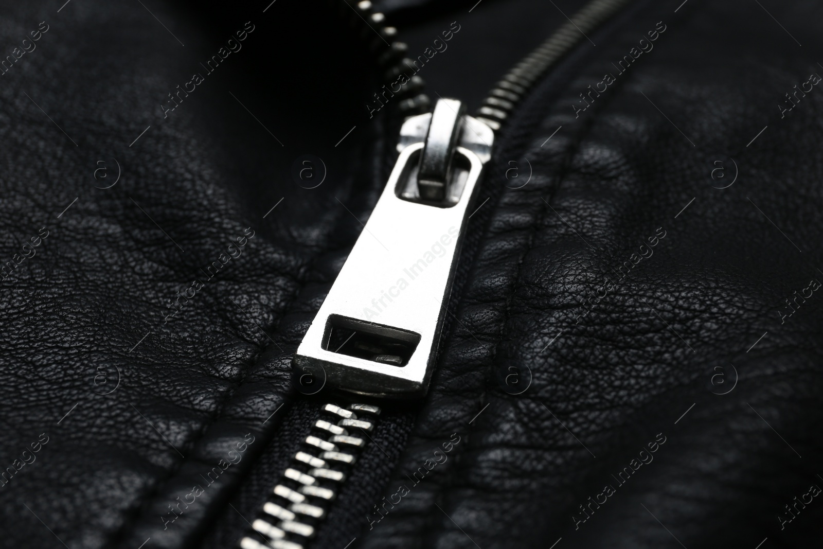 Photo of Closeup view of black leather jacket with zipper as background