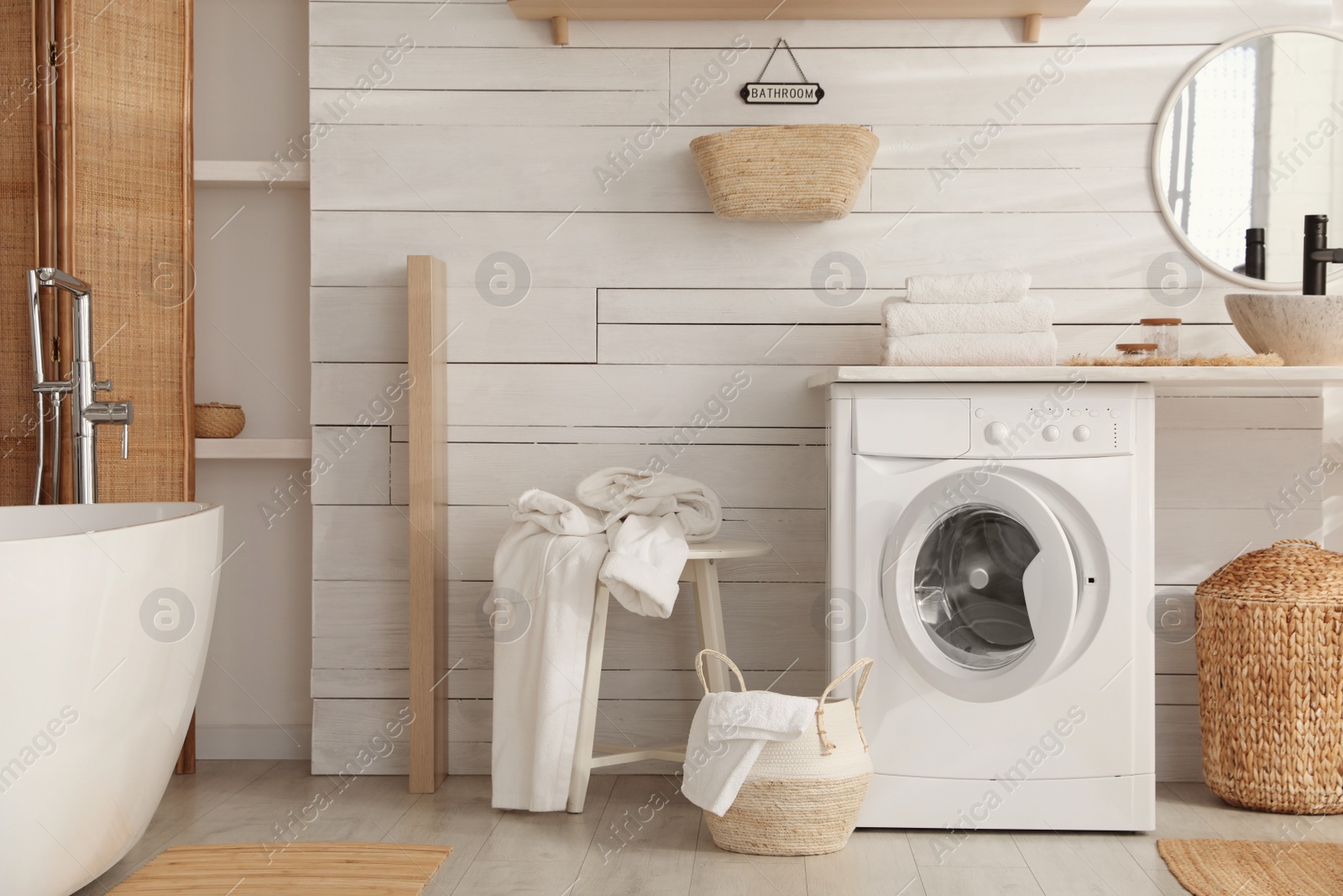 Photo of Stylish bathroom interior with modern washing machine