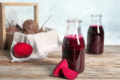 Bottle of beet smoothie on wooden table