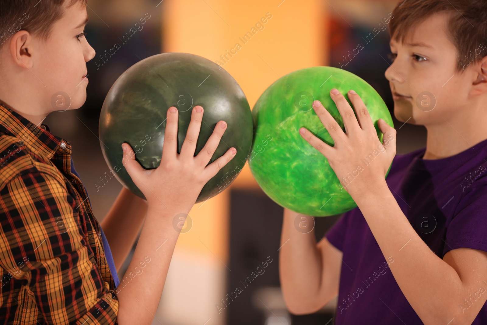 Photo of Happy boys with balls in bowling club