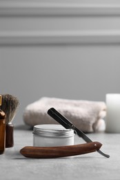 Photo of Set of men's shaving tools on grey table. Space for text