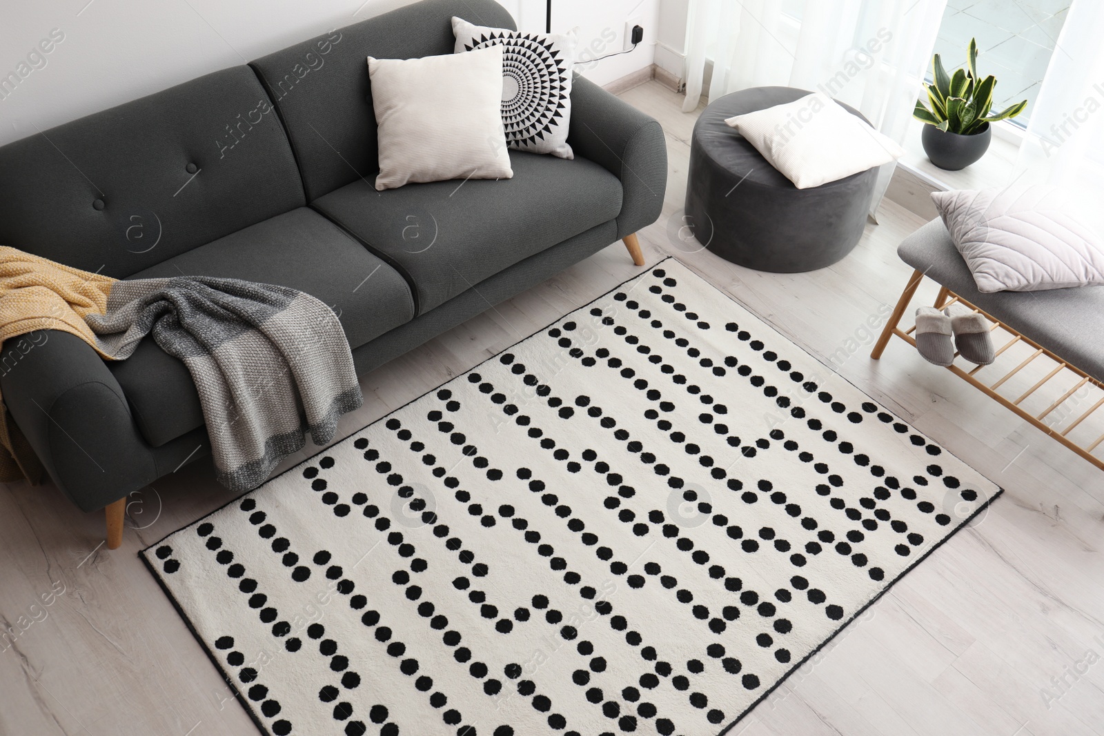 Photo of Living room interior with comfortable sofa and stylish rug, above view