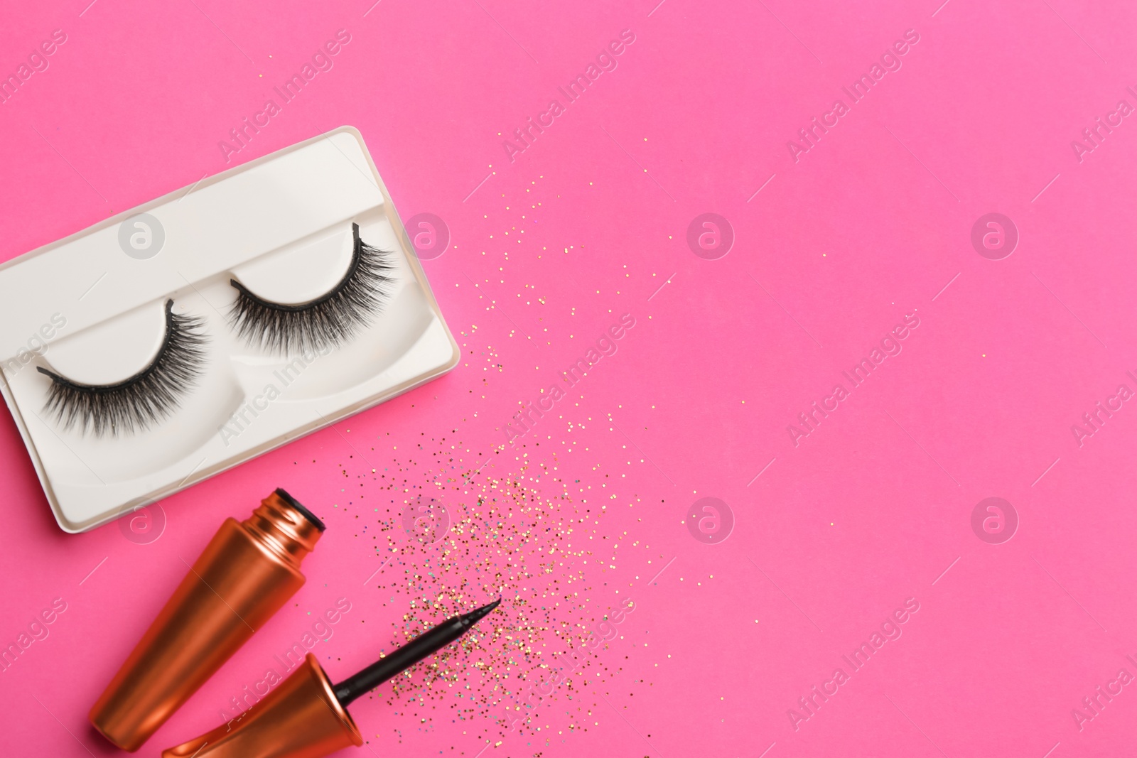 Photo of Flat lay composition with magnetic eyelashes and accessories on crimson background. Space for text
