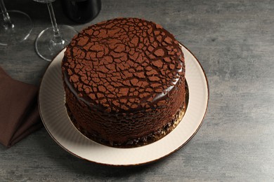 Delicious chocolate truffle cake on grey textured table