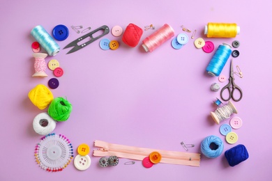 Photo of Flat lay composition with different threads and sewing accessories on color background