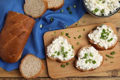 Photo of Bread with cottage cheese and green onion on wooden table, flat lay