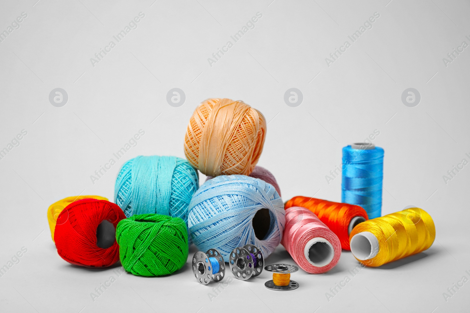 Photo of Color sewing threads on white background