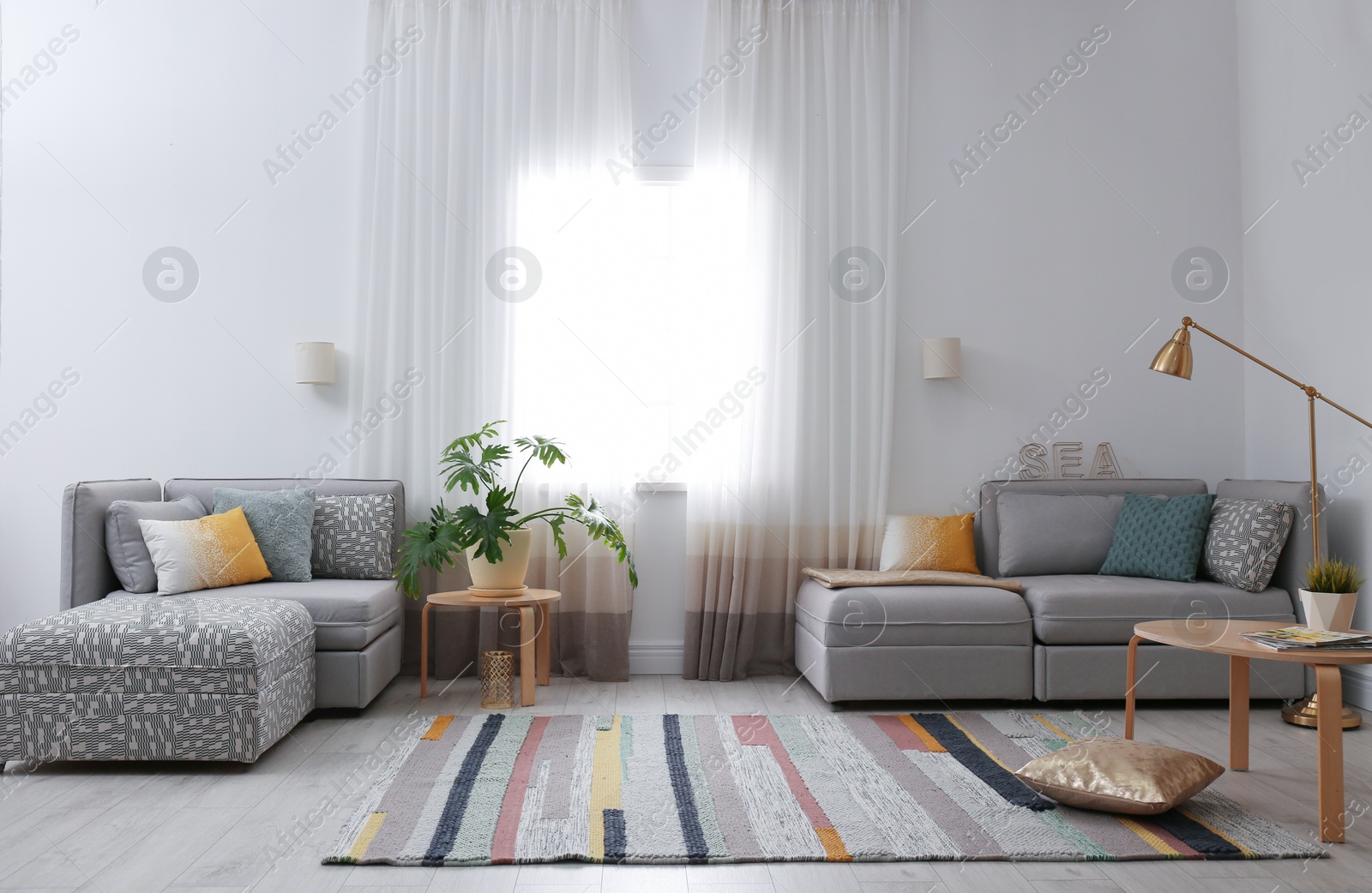 Photo of Modern living room interior with comfortable sofa near window
