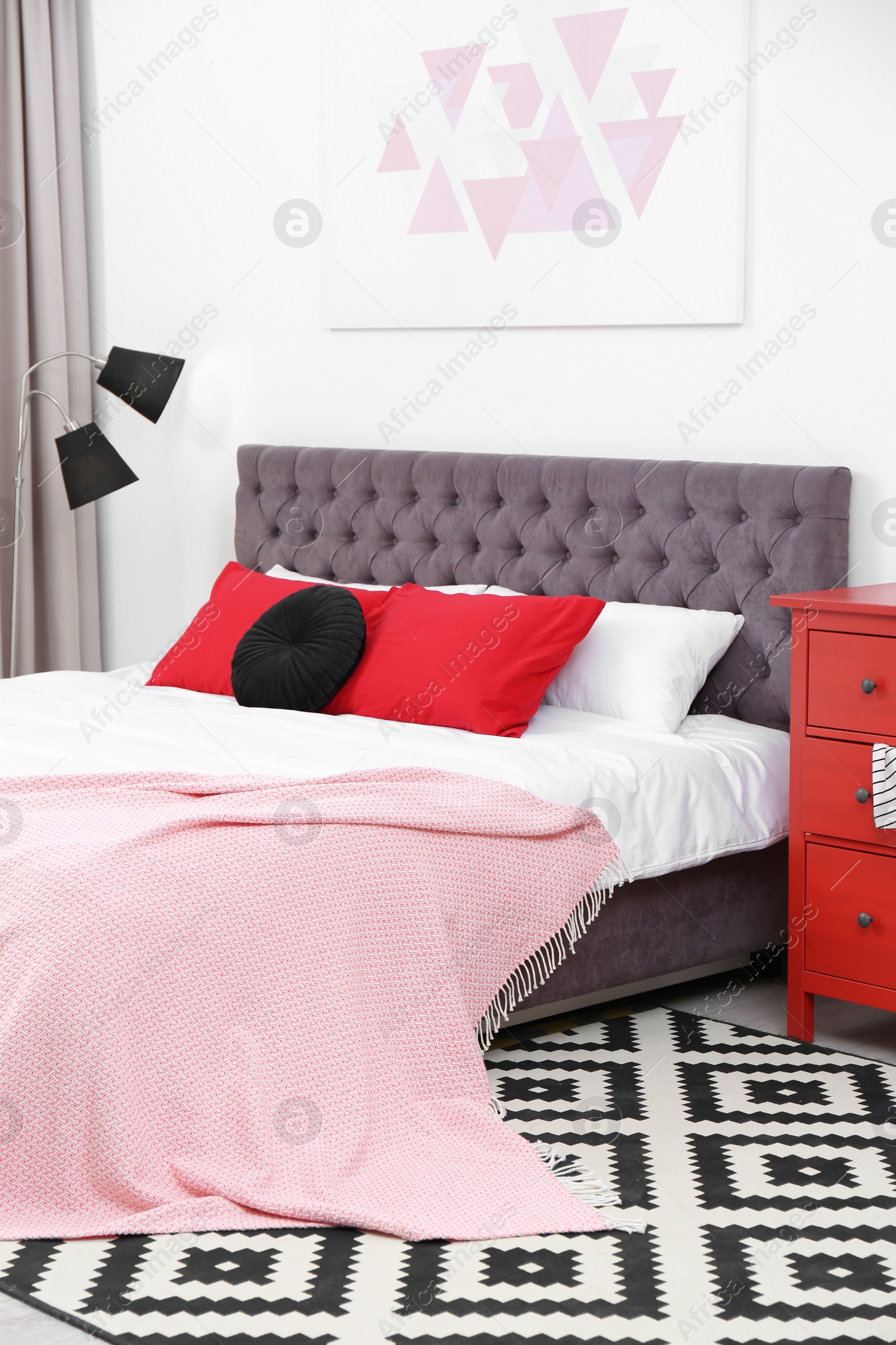 Photo of Stylish room interior with large comfortable bed