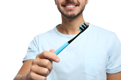 Photo of Young man with toothbrush on white background, closeup