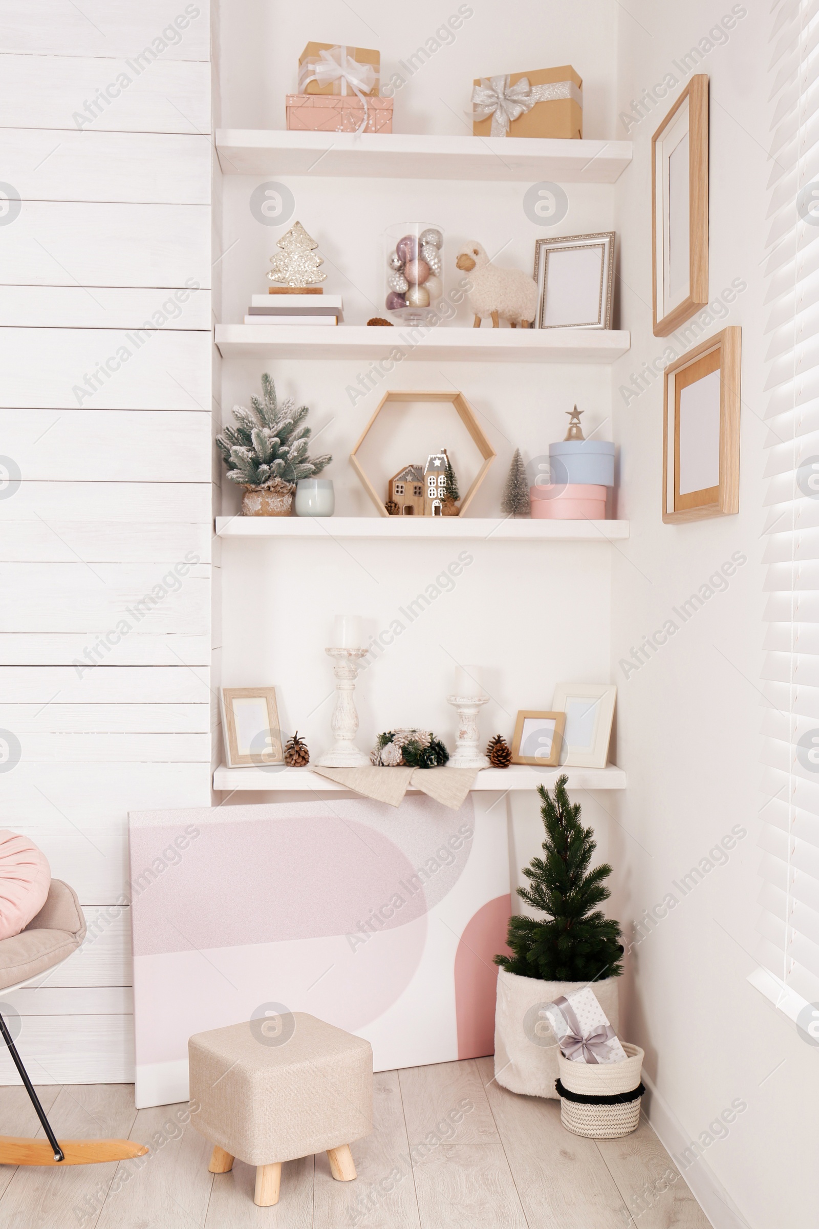 Photo of Wall shelves with beautiful Christmas decor indoors. Interior design