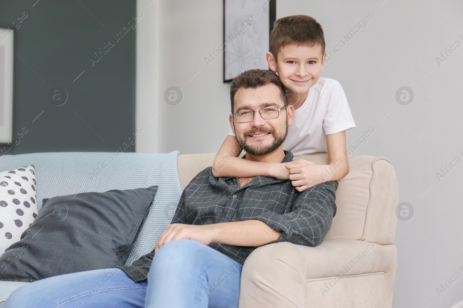 Photo of Little boy and his dad spending time together at home