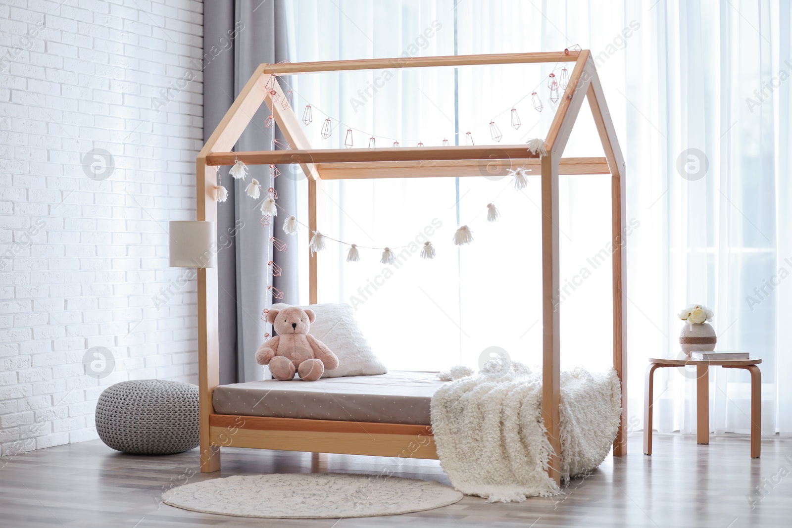 Photo of Stylish child room interior with cute wooden bed