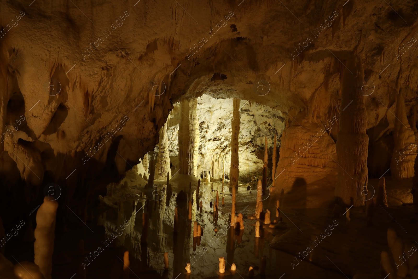 Photo of Many stalactite and stalagmite formations inside cave