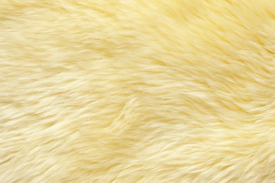 Texture of yellow faux fur as background, closeup