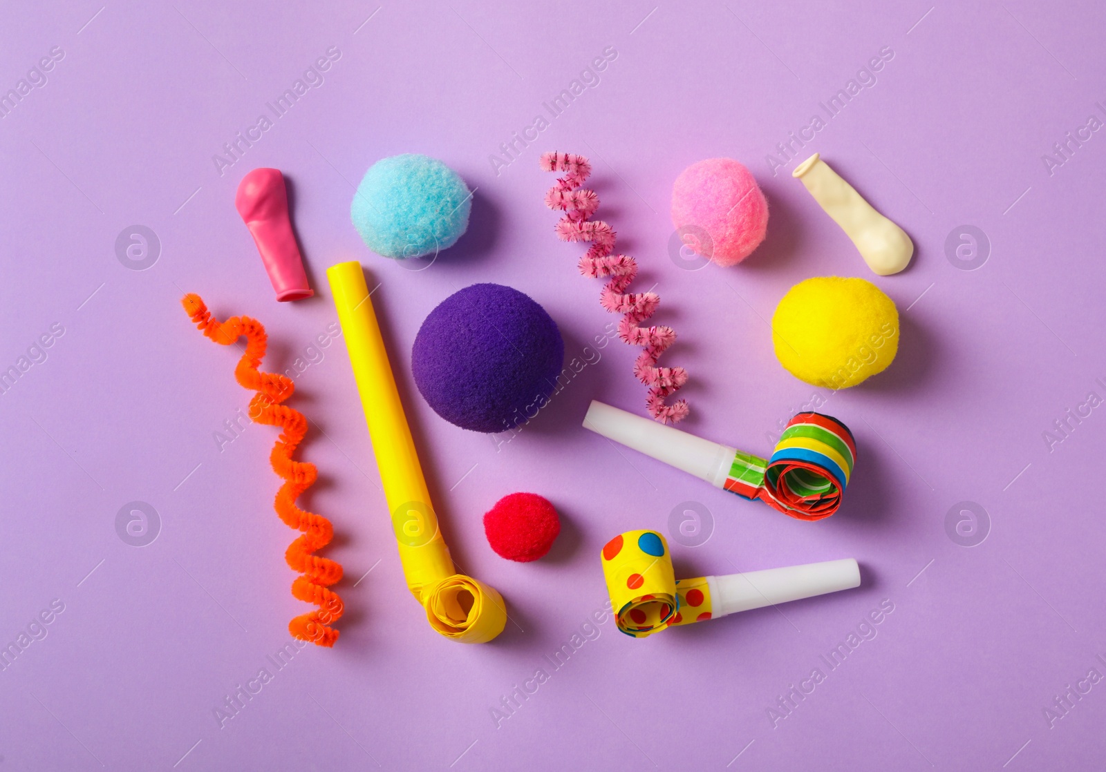 Photo of Different clown's accessories on lilac background, flat lay