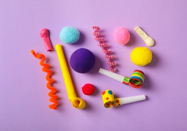 Photo of Different clown's accessories on lilac background, flat lay