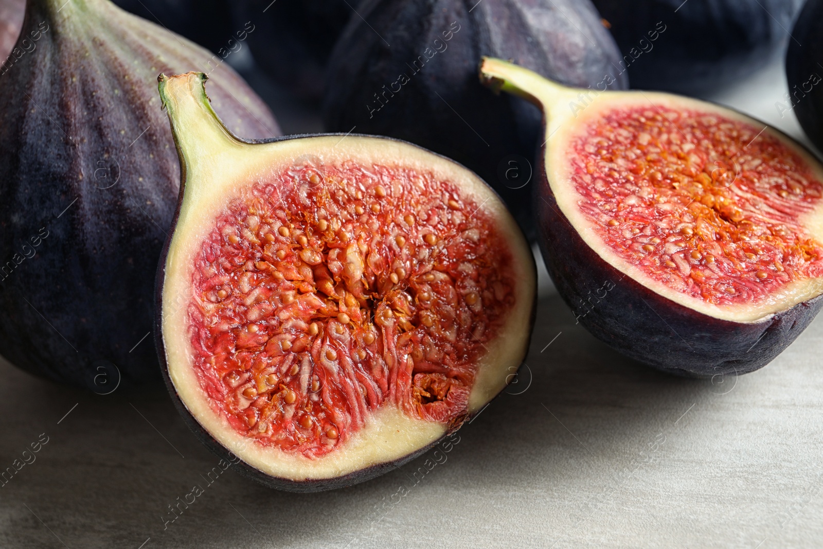 Photo of Bunch of fresh ripe figs on light background. Tropical fruit