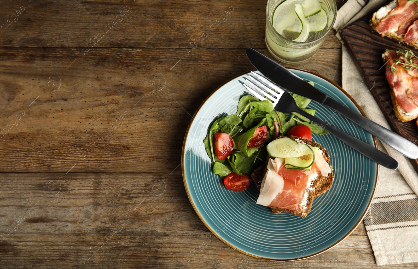 Photo of Flat lay composition with delicious bruschetta on wooden table, space for text