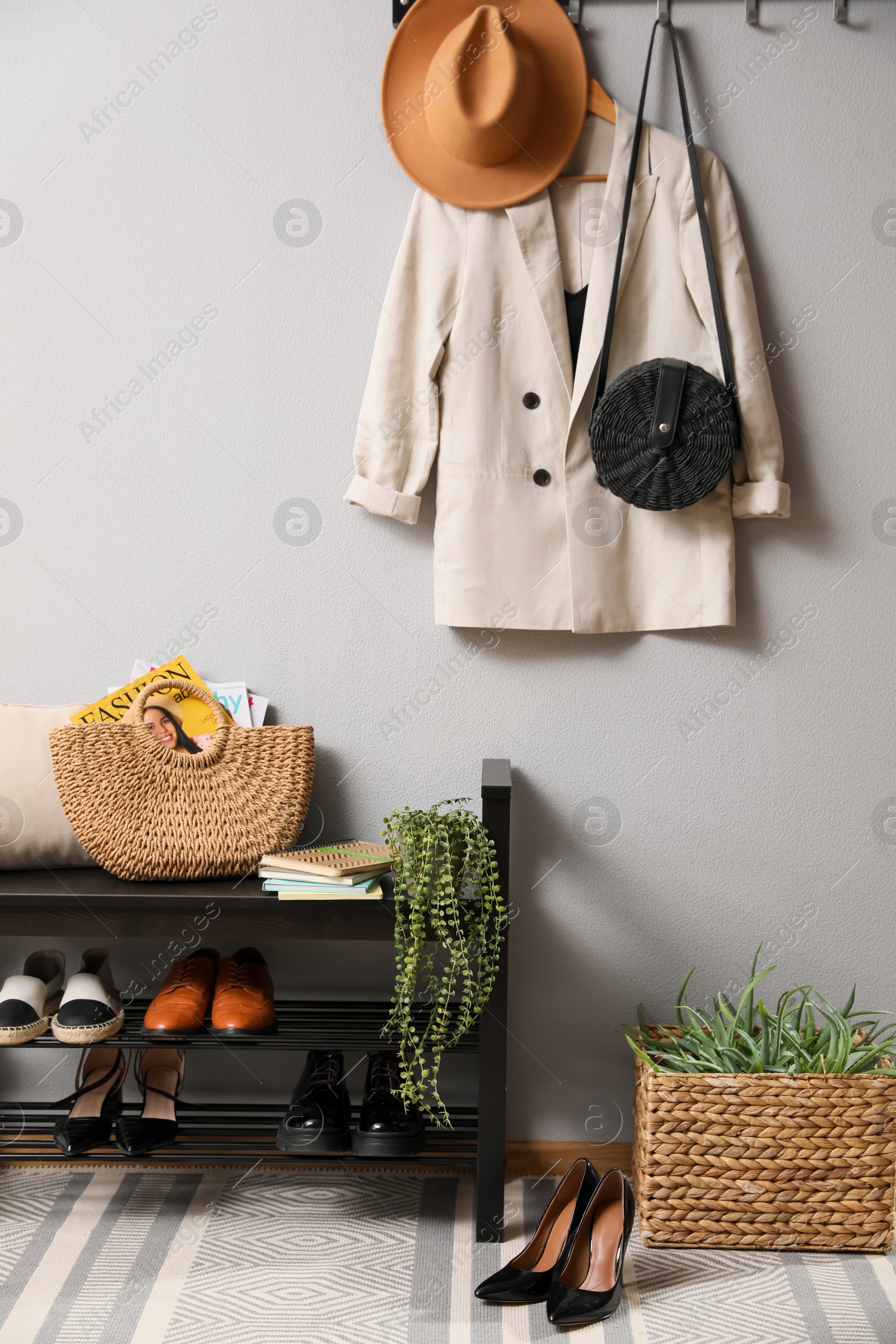 Photo of Hallway interior with stylish furniture, clothes and accessories