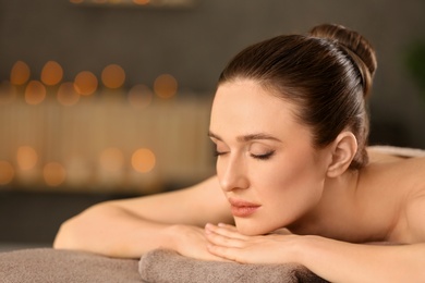 Photo of Beautiful young woman relaxing in spa salon