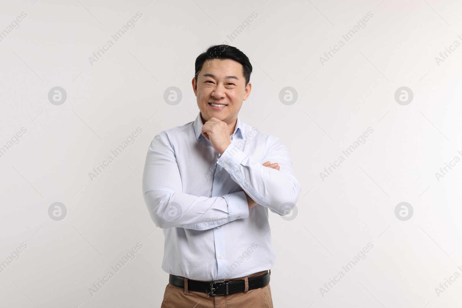 Photo of Portrait of happy man on light background