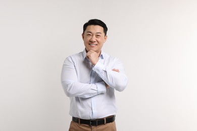 Portrait of happy man on light background