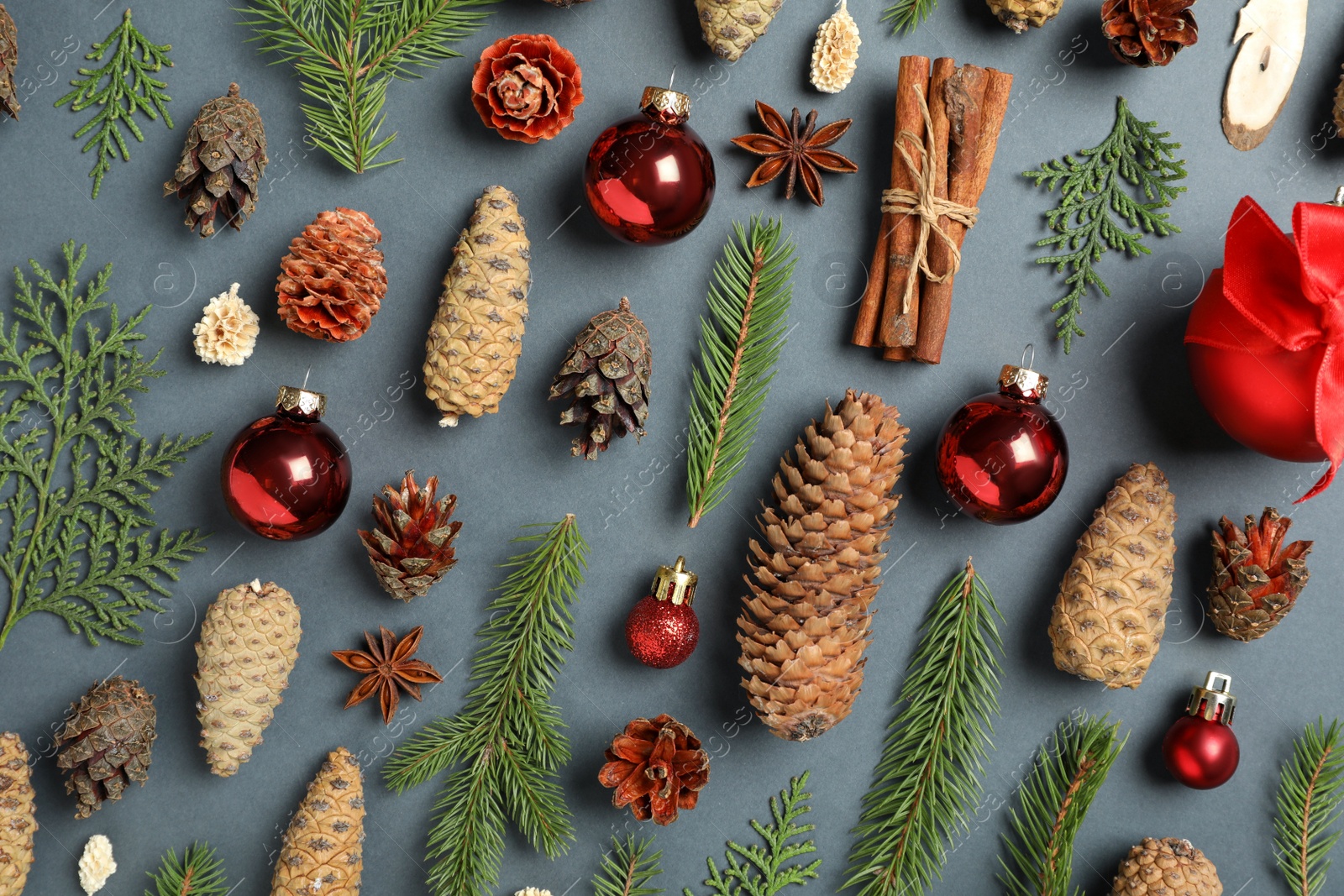 Photo of Flat lay composition with pinecones on dark background