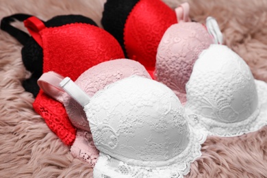 Photo of Beautiful lace bras on faux fur. Stylish underwear