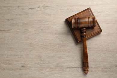 Wooden gavel on light table, top view. Space for text