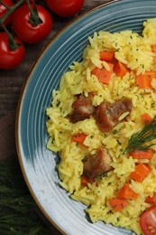 Photo of Delicious pilaf with meat and ingredients on table, flat lay