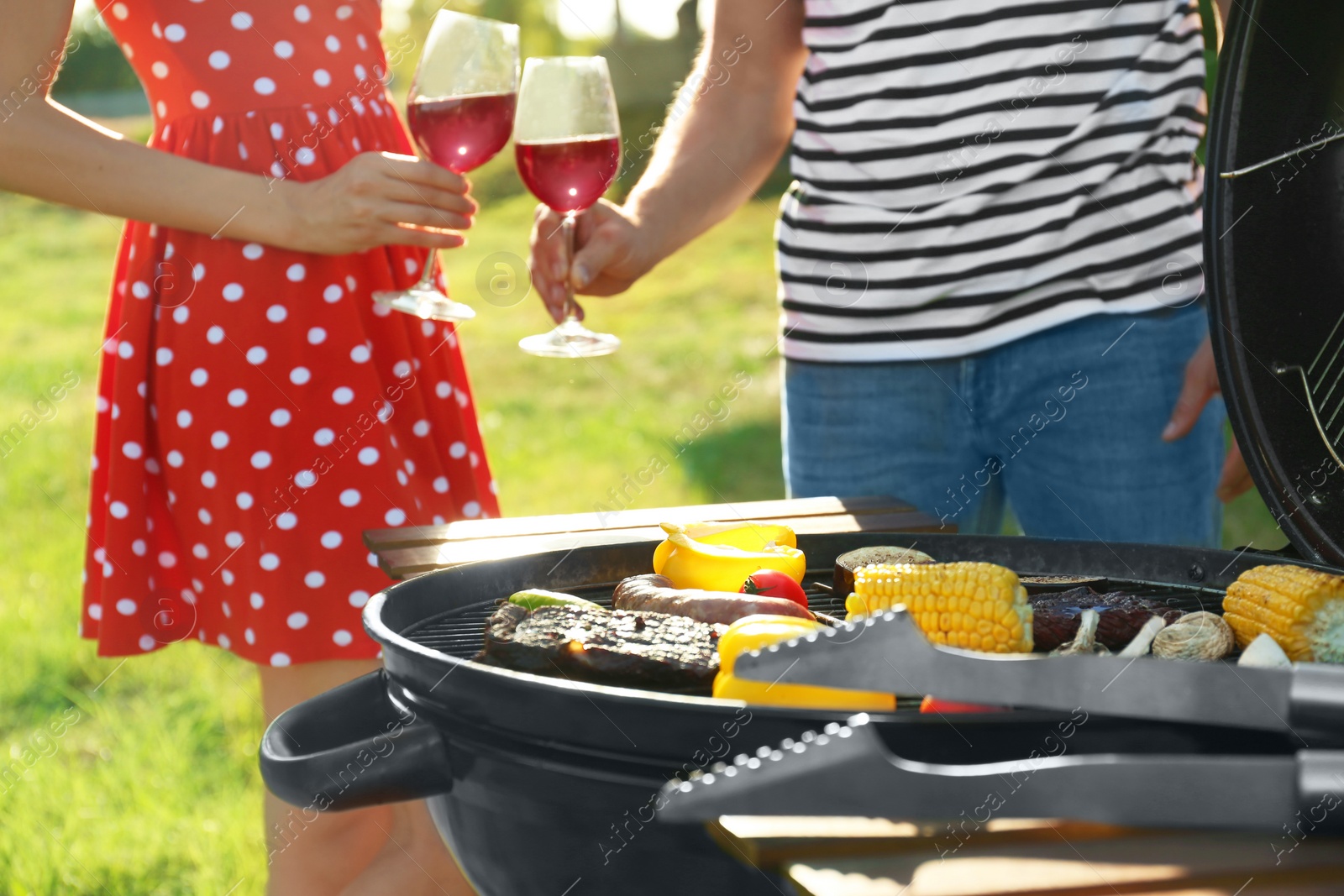 Photo of Couple having barbecue in park, closeup view