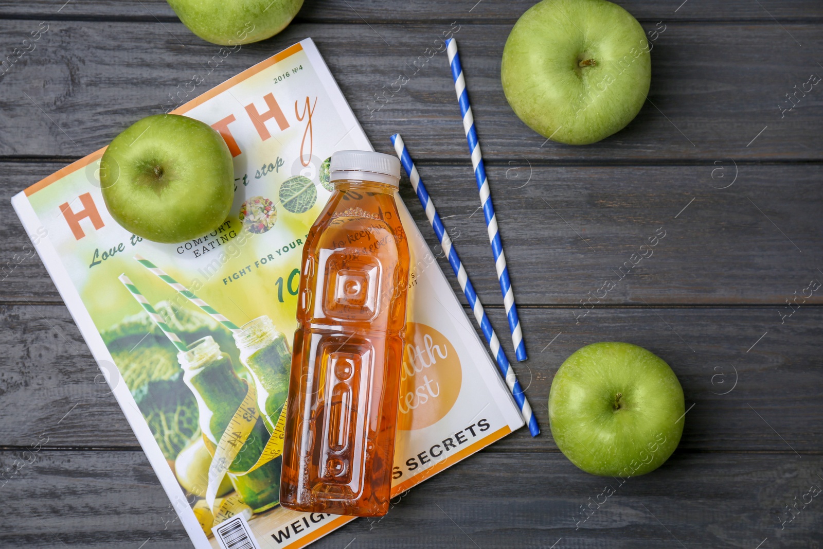 Photo of Composition with fresh apple juice on wooden table, top view