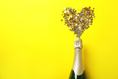 Photo of Creative flat lay composition with bottle of champagne and space for text on color background