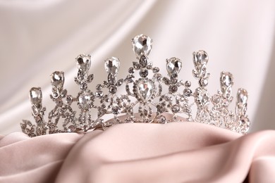 Beautiful silver tiara with diamonds on light cloth
