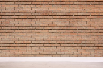 Room with brick wall and wooden floor