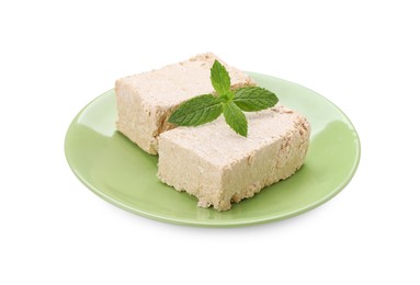 Photo of Plate with pieces of tasty halva and mint isolated on white