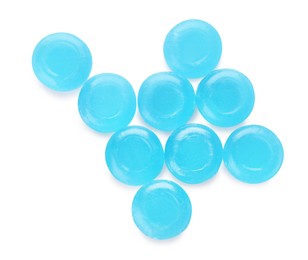 Photo of Many light blue cough drops on white background, top view