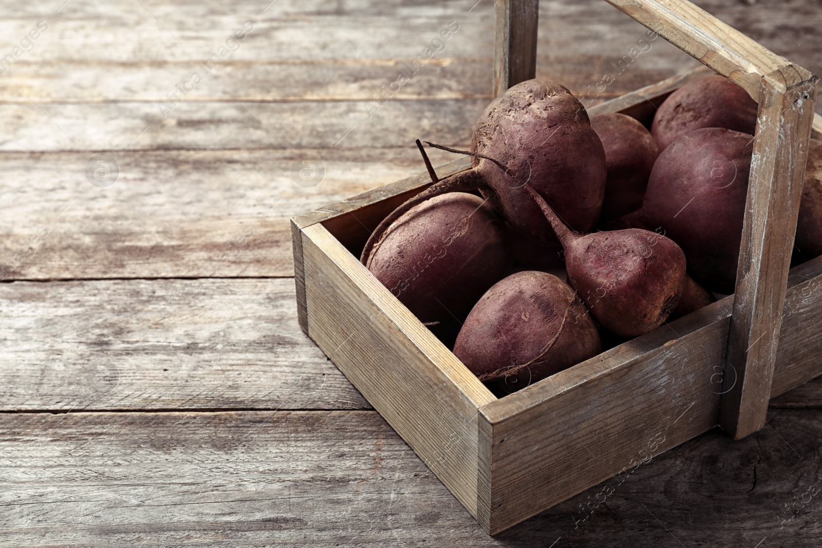 Photo of Box with whole fresh beets on wooden table