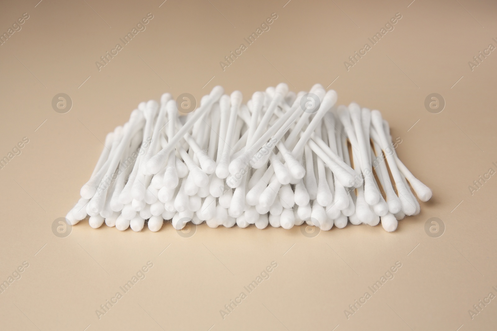 Photo of Many clean cotton buds on beige background