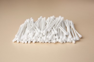 Photo of Many clean cotton buds on beige background