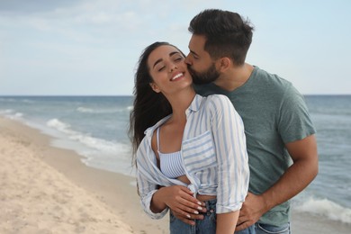 Photo of Lovely couple spending time together on beach