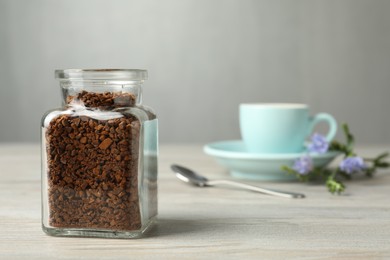 Photo of Jar of chicory granules on white wooden table, space for text