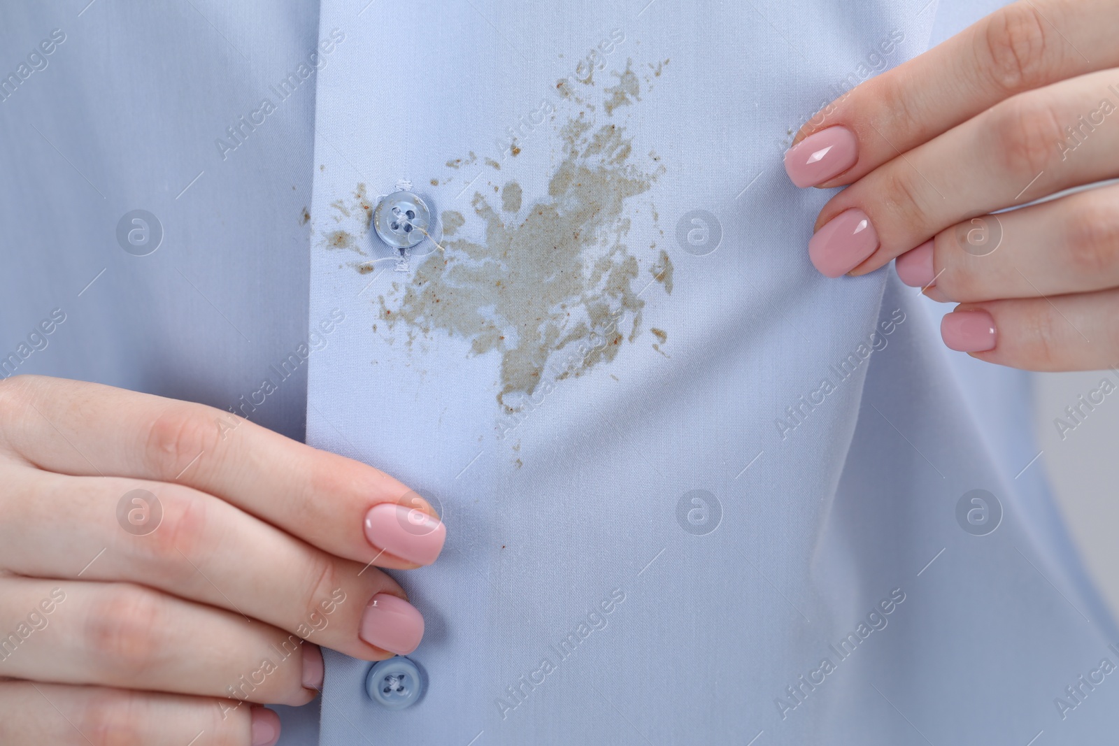 Photo of Woman showing stain on her shirt, closeup